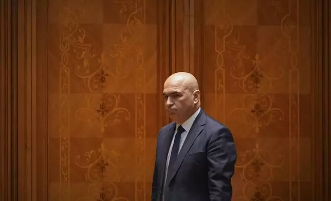 Romanian Prime Minister designate Ilie Bolojan arrives for a joint parliament session ahead of a vote of confidence for the new government team in Bucharest, Romania, Monday, June 23, 2025. (AP Photo/Andreea Alexandru)