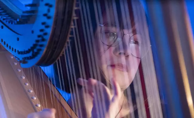 A member of the Vienna Symphony Orchestra plays on harp during "The Blue Danube" waltz as it is transmitted into deep space towards Voyager 1. in Vienna, Austria, on Saturday, May 31, 2025. (AP Photo/Denes Erdos)