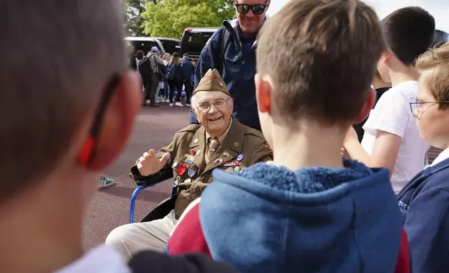 World War II veteran Wilbur "Jack" Myers, a 101-year-old who fought in the U.S. Army's 692nd Tank Destroyer Battalion, greets schoolchildren during a visit on Monday, June 2, 2025 in Colleville-sur-Mer, to the Normandy American Cemetery that is the final resting place for nearly 9,400 American war dead and which overlooks Omaha beach, one of the D-D-day invasion zones on June 6, 1944. (AP Photo/John Leicester)