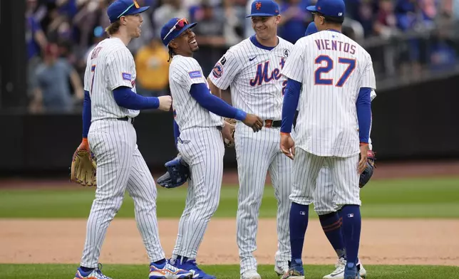 New York Mets players, including Brett Baty, left, Francisco Lindor, second from left, Pete Alonso, second from right, and Mark Vientos (27), celebrate after a baseball game against the Colorado Rockies, Sunday, June 1, 2025, in New York. (AP Photo/Seth Wenig)