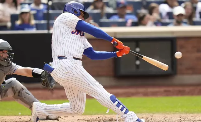New York Mets' Juan Soto hits a solo home run during the eighth inning of a baseball game against the Colorado Rockies, Sunday, June 1, 2025, in New York. (AP Photo/Seth Wenig)