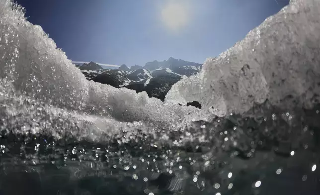 The sun shines over the melting Rhone Glacier near Goms, Switzerland, June 10, 2025. (AP Photo/Matthias Schrader)
