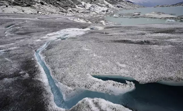Water flows from the melting Rhone Glacier near Goms, Switzerland, June 10, 2025. (AP Photo/Matthias Schrader)