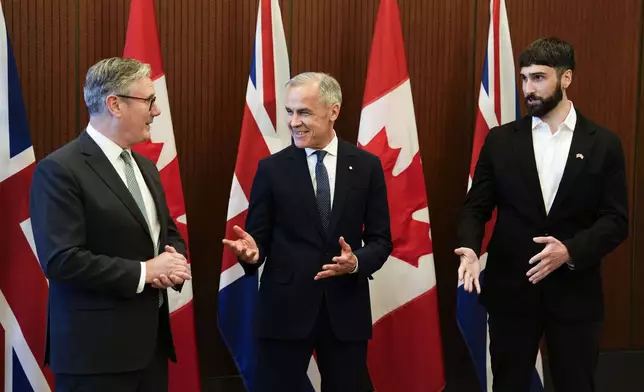 Prime Minister of Canada Mark Carney, centre, and Prime Minister of the United Kingdom Keir Starmer, left, meet with Aidan Gomez, CEO of AI startup Cohere, in Ottawa on Sunday, June 15, 2025. (Justin Tang/The Canadian Press via AP)