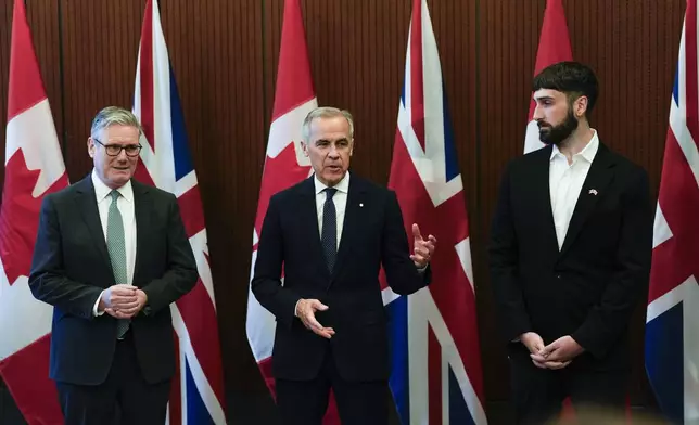 Prime Minister of Canada Mark Carney, centre, and Prime Minister of the United Kingdom Keir Starmer, left, meet with Aidan Gomez, CEO of AI startup Cohere, in Ottawa on Sunday, June 15, 2025. (Justin Tang/The Canadian Press via AP)