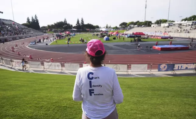Mary Davis wears a T-shirt opposing transgender participation in girls' sports during the California high school track-and-field championships in Clovis, Calif., Saturday, May 31, 2025. (AP Photo/Jae C. Hong)