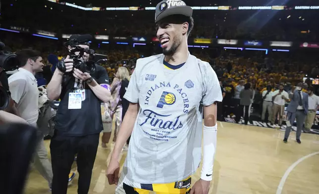 Indiana Pacers guard Tyrese Haliburton, center, reacts after winning Game 6 of the Eastern Conference finals of the NBA basketball playoffs against the New York Knicks in Indianapolis, Saturday, May 31, 2025. (AP Photo/Michael Conroy)