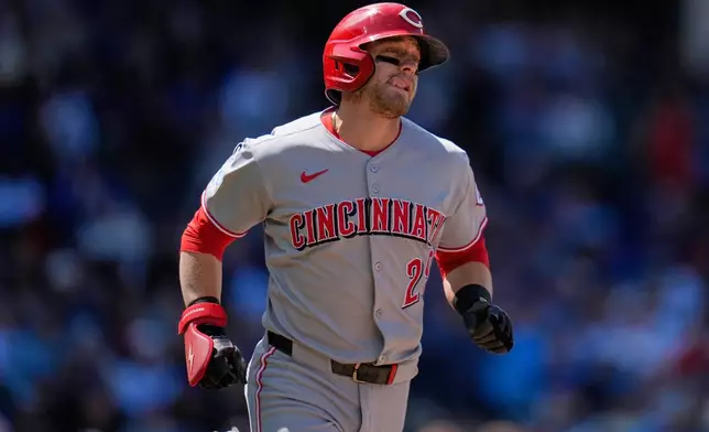 Cincinnati Reds' TJ Friedl (29) runs to first after hitting a single during the sixth inning of a baseball game against the Chicago Cubs, Saturday, May 31, 2025, in Chicago. (AP Photo/Erin Hooley)