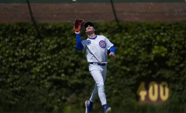 Chicago Cubs center fielder Pete Crow-Armstrong (4) catches a fly out from Cincinnati Reds' Matt McLain (9) during the sixth inning of a baseball game Saturday, May 31, 2025, in Chicago. (AP Photo/Erin Hooley)