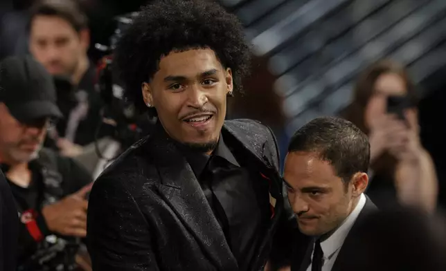 Dylan Harper reacts after being selected second by the San Antonio Spurs In the first round of the NBA basketball draft, Wednesday, June 25, 2025, in New York. (AP Photo/Adam Hunger)