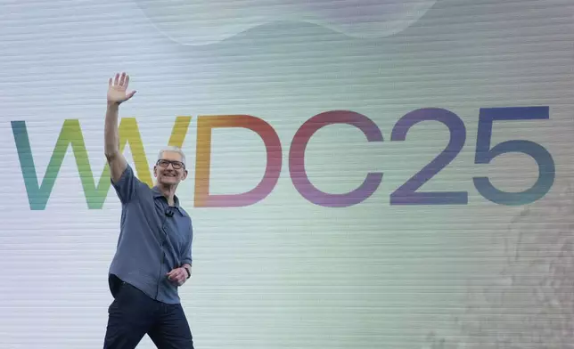 Apple CEO Tim Cook waves to attendees during an event on the Apple campus in Cupertino, Calif., Monday, June 9, 2025. (AP Photo/Jeff Chiu)