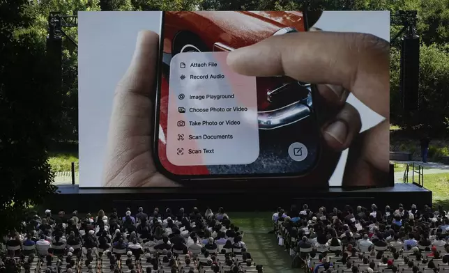Attendees watch a presentation during an event on the Apple campus in Cupertino, Calif., Monday, June 9, 2025. (AP Photo/Jeff Chiu)