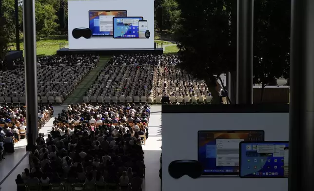 Attendees watch a presentation during an event on the Apple campus in Cupertino, Calif., Monday, June 9, 2025. (AP Photo/Jeff Chiu)