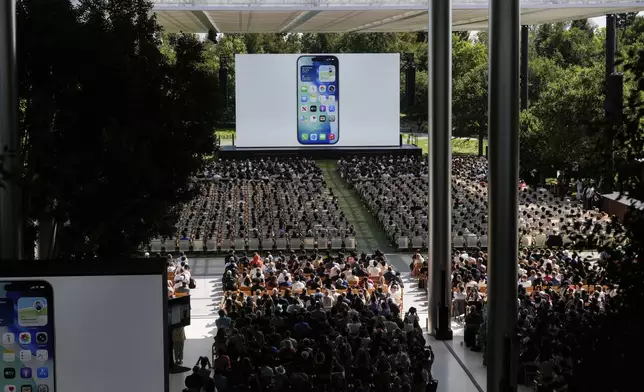 Attendees watch a presentation during an event on the Apple campus in Cupertino, Calif., Monday, June 9, 2025. (AP Photo/Jeff Chiu)