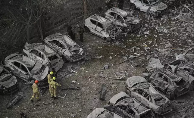 Firefighters inspect the site struck by an Iranian missile strike that killed several people, in Beersheba, Israel, on Tuesday, June 24, 2025. (AP Photo/Leo Correa)