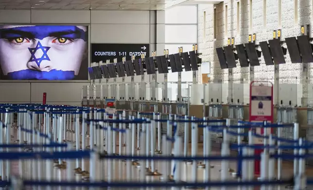 Israel's Ben Gurion Airport is empty of passengers following an Israeli military strike on Iran, in Lod, near Tel Aviv, Israel, Friday, June 13, 2025. (AP Photo/Ariel Schalit)