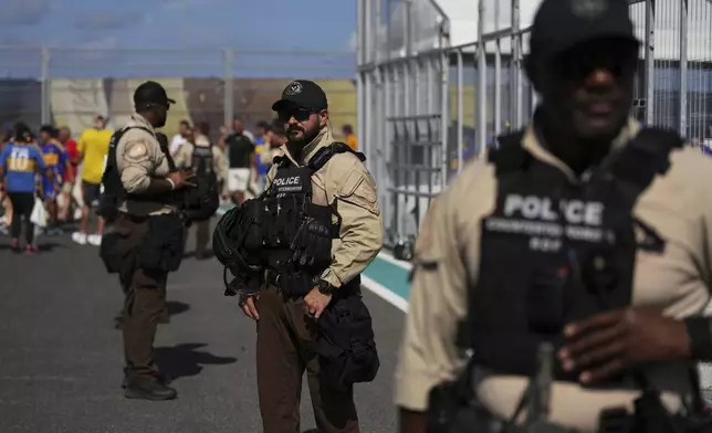Law enforcement personnel stand outside the stadium prior to the Club World Cup group C soccer match between Boca Juniors and Benfica in Miami Gardens, Fla., Monday, June 16, 2025. (AP Photo/Rebecca Blackwell)