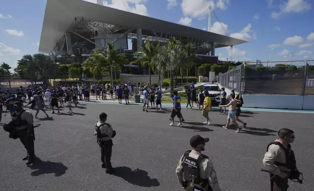 Law enforcement personnel stand outside the stadium prior to the Club World Cup group C soccer match between Boca Juniors and Benfica in Miami Gardens, Fla., Monday, June 16, 2025. (AP Photo/Rebecca Blackwell)
