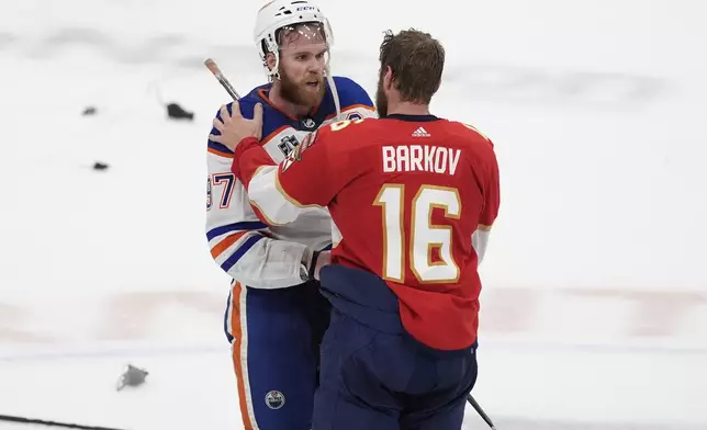 FILE - Florida Panthers center Aleksander Barkov (16) talks to Edmonton Oilers center Connor McDavid (97) at the end of Game 7 of the NHL hockey Stanley Cup Final, Monday, June 24, 2024, in Sunrise, Fla. (AP Photo/Rebecca Blackwell, File)