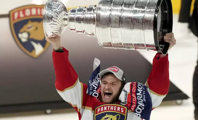 FILE - Florida Panthers forward Aleksander Barkov hoists the Stanley Cup after defeating the Edmonton Oilers in Game 7 of the NHL hockey Stanley Cup Final, Monday, June 24, 2024, in Sunrise, Fla. (Nathan Denette/The Canadian Press via AP, File)