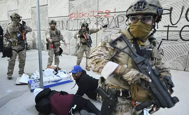 EDS NOTE: OBSCENITY - Agents from US Customs and Border Protection surround demonstrators during protests on Thursday, June 12, 2025, in Los Angeles (AP Photo/Wally Skalij)