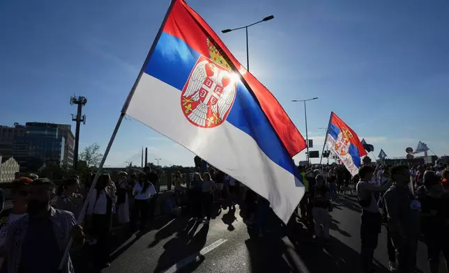 People block a highway during a protest seven months after the deadly train station tragedy that sparked mass demonstrations against corruption in Belgrade, Serbia, Sunday, June 1, 2025. (AP Photo/Darko Vojinovic)