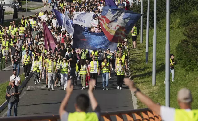 People march during a protest, seven months after the deadly train station tragedy that sparked mass demonstrations against corruption in Belgrade, Serbia, Sunday, June 1, 2025. (AP Photo/Darko Vojinovic)