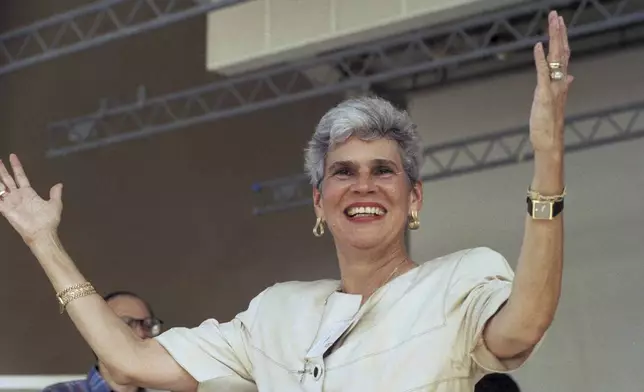 FILE - Nicaraguan presidential candidate Violeta Chamorro raises her arms as she receives a warm welcome during her visit to Miami on Sept. 17, 1989. Barrios de Chamorro, a simple housewife thrust into Nicaraguan politics by the assassination of her husband and who, as president, ended a civil war, died on Saturday, June 14, 2025, in San José, Costa Rica, her family said in a statement. She was 95. (AP Photo/Kathy Willens, File)