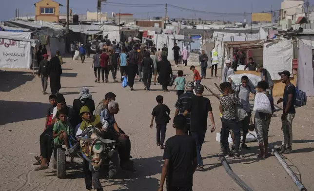 Displaced Palestinians carrying their belongings in Rafah, southern Gaza Strip on Saturday, June 7, 2025. (AP Photo/Jehad Alshrafi)