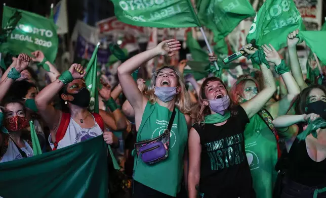 FILE - Abortion rights activists watch live video streaming of lawmakers in session, in Buenos Aires, Argentina, Dec. 30, 2020, as Congress approves a bill that legalizes abortion. (AP Photo/Natacha Pisarenko, File)