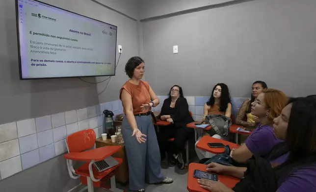 Carla de Castro, a sociologist, researcher and educator, talks about abortion during a circle conversation to provide guidance on reproductive rights, at the Women's House of Mare in Rio de Janeiro, Tuesday, May 20, 2025. (AP Photo/Bruna Prado)