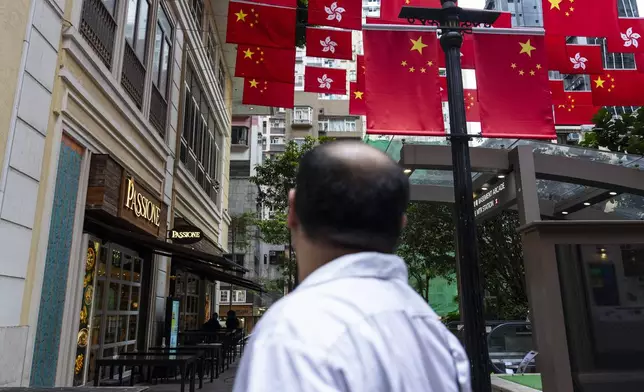 Chinese and Hong Kong SAR flags are hung outside restaurants in Hong Kong, Thursday, June 26, 2025. (AP Photo/Chan Long Hei)
