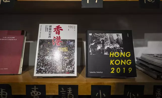 Books about Hong Kong politics are displayed on bookshelf at Leticia Wong's bookstore in Hong Kong, Friday, June 20, 2025. (AP Photo/Chan Long Hei)