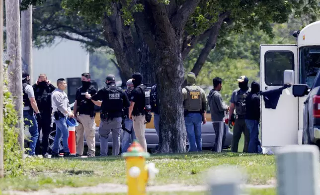 Federal agents are seen near Glenn Valley Foods in Omaha, Neb., Tuesday, June 10, 2025. (Nikos Frazier/Omaha World-Herald via AP)