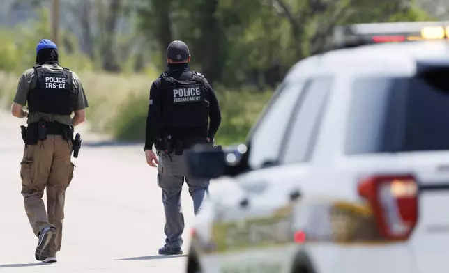 Federal agents are seen near Glenn Valley Foods in Omaha, Neb., Tuesday, June 10, 2025. (Nikos Frazier/Omaha World-Herald via AP)