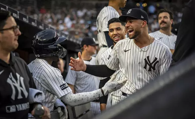 New York Yankees catcher J.C. Escarra (25) congratulates Jazz Chisholm Jr. (13) on his home run during the second inning of a baseball game against the Los Angeles Angels, Wednesday, June 18, 2025, in New York. (AP Photo/Angelina Katsanis)