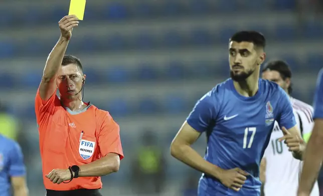 Referee Viktor Shimusik shows a yellow card to Azerbaijan's Tural Bayramov during an international friendly soccer match at Dalga Arena in Baku, Azerbaijan, Tuesday, June 10, 2025. (AP Photo)
