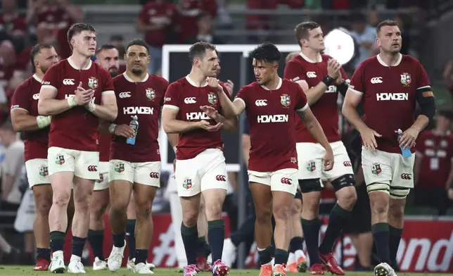Lions' Marcus Smith, third right, gestures, as he, and teammates walk round the pitch as they acknowledge the fan after the end of the Rugby Union international match between the British and Irish Lions and Argentina, at the Aviva Stadium in Dublin, Friday, June 20, 2025. (AP Photo/Peter Morrison)