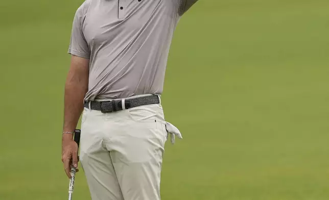 Rory McIlroy, of Northern Ireland, reacts as fans continue to move near the seventh green as he prepares to play his shot during the third round of the U.S. Open golf tournament at Oakmont Country Club Saturday, June 14, 2025, in Oakmont, Pa. (AP Photo/Carolyn Kaster)