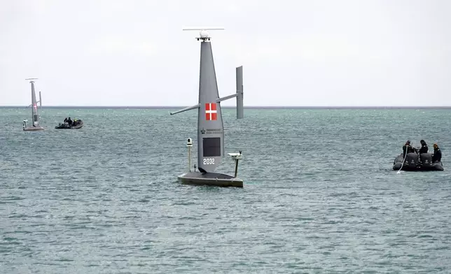 Workers deploy a Saildrone "Voyager", uncrewed surface vehicle (USV), into the Baltic Sea at the Koge Marina in Koge, eastern Denmark, Monday, June 16, 2025. (AP Photo/James Brooks)