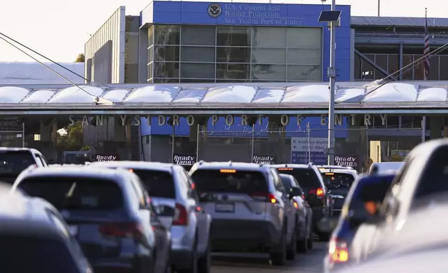 FILE - Vehicles wait in line to cross the border into the United States at the San Ysidro Port of Entry, March 18, 2025, in Tijuana, Mexico. (AP Photo/Gregory Bull, File)