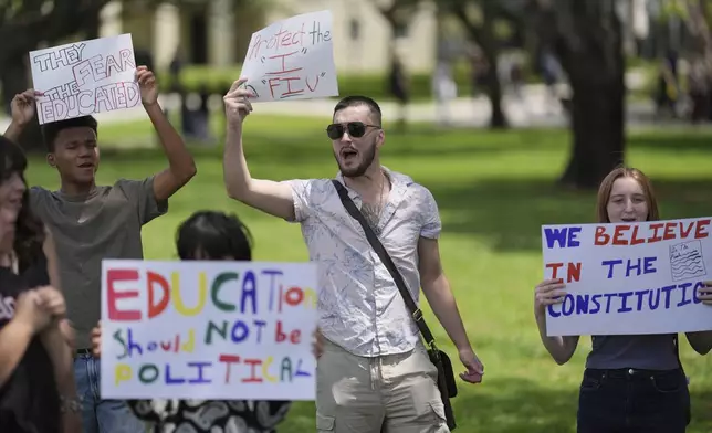 FILE - A group of Florida International University students protest against cuts in federal funding and an agreement by campus police to partner with Immigration and Customs Enforcement, on the FIU campus on a day of protests around the country in support of higher education, April 17, 2025, in Miami. (AP Photo/Rebecca Blackwell, File)