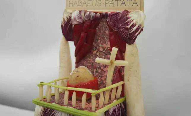 A vegetable sculpture entitled 'Habaeus Patata enters in the vegetable sculpture competition at Lambeth County show in London, Saturday, June 7, 2025. (AP Photo/Joanna Chan)