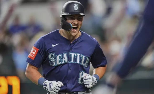 Seattle Mariners' Dominic Canzone celebrates his solo home run in the third inning of a baseball game against the Texas Rangers, Saturday, June 28, 2025, in Arlington, Texas. (AP Photo/Tony Gutierrez)
