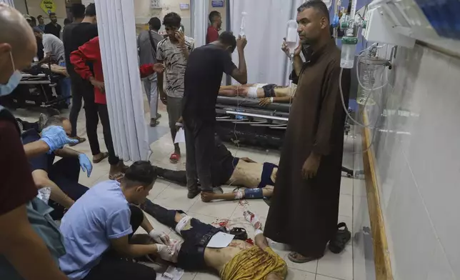 Palestinians wounded while returning from one of the Gaza Humanitarian Foundation distribution centers operated by the U.S.-backed organization, according to Nasser Hospital, are treated in Khan Younis, Monday, June 30, 2025. (AP Photo/Mariam Dagga)