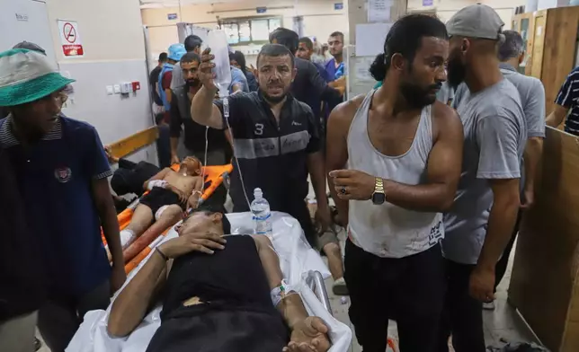 Palestinians wounded while returning from one of the Gaza Humanitarian Foundation distribution centers operated by the U.S.-backed organization, according to Nasser Hospital, are treated in Khan Younis, Monday, June 30, 2025. (AP Photo/Mariam Dagga)