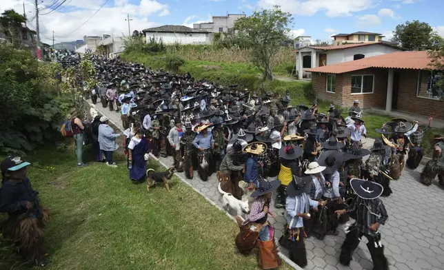 Indigenous people dance during the traditional Inti Raymi, or Festival of the Sun, coinciding with the winter solstice in Cotacachi, Ecuador, Tuesday, June 24, 2025. (AP Photo/Dolores Ochoa)