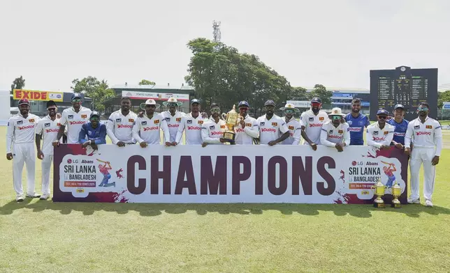Sri Lankan team members pose for photographers during the fourth day of the second cricket test match between Sri Lanka and Bangladesh in Colombo, Sri Lanka, Saturday, June 28, 2025. (AP Photo/Eranga Jayawardena)
