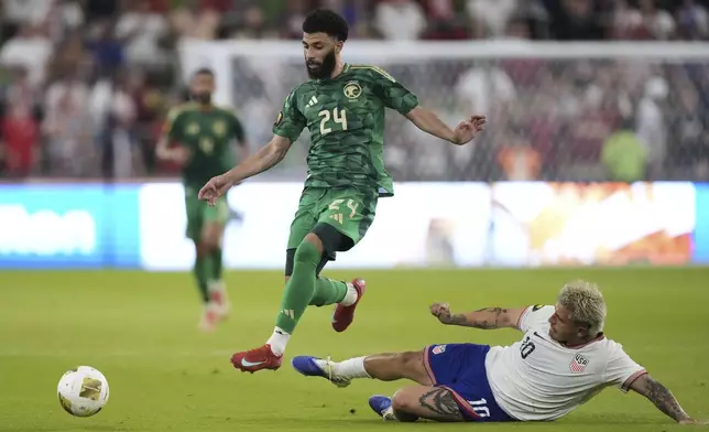 Saudi Arabia's Abdulrahman Aloboud (24) leaps over United States' Diego Luna (10) as he keeps control of the ball during a CONCACAF Gold Cup soccer match, Thursday, June 19, 2025, in Austin, Texas. (AP Photo/Eric Gay)