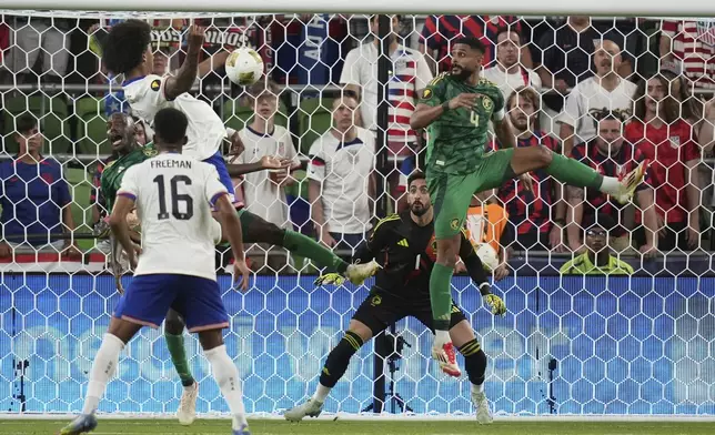 Saudi Arabia's Nawaf Alaqidi (1) and Abdulelah Alamri (4) look to block a shot by United States' Chris Richards, left, during a CONCACAF Gold Cup soccer match, Thursday, June 19, 2025, in Austin, Texas. (AP Photo/Eric Gay)